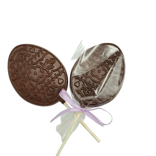 Chocolate lollipops with intricate designs on a white background